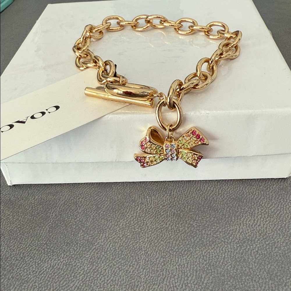 Coach Gold Bracelet with Multicolor Gem Encrusted Bow Charm New in Box - Picture 7 of 7
